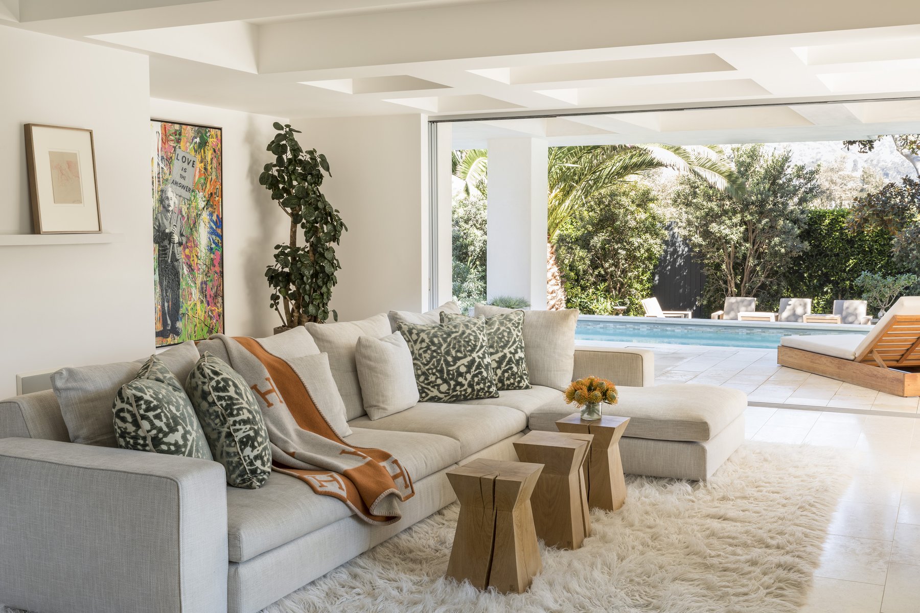 Living space opening to a pool courtyard, Malibu residence by Naomi Stroh Interiors